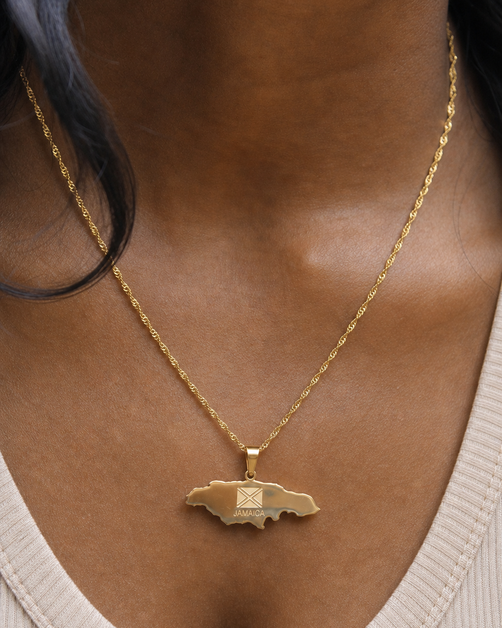 Gold necklace with a pendant worn by a person