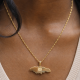 Gold necklace with a pendant worn by a person