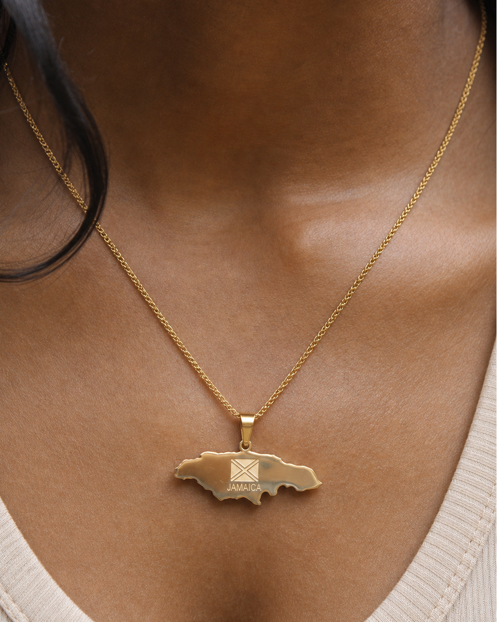 Gold necklace with a pendant worn by a person
