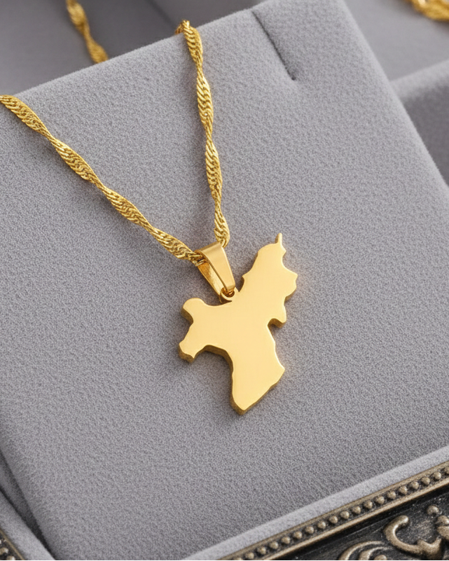 Gold necklace with a map pendant on a gray jewelry display box