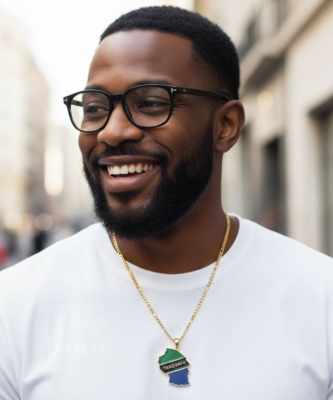Man wearing glasses and a white shirt with a necklace featuring a green and blue pendant.